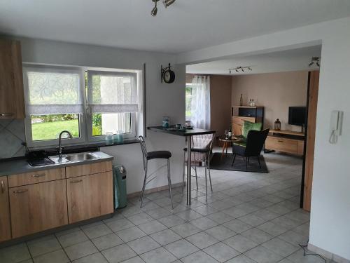 a kitchen and living room with a table and chairs at FEWO Kug in Mengen