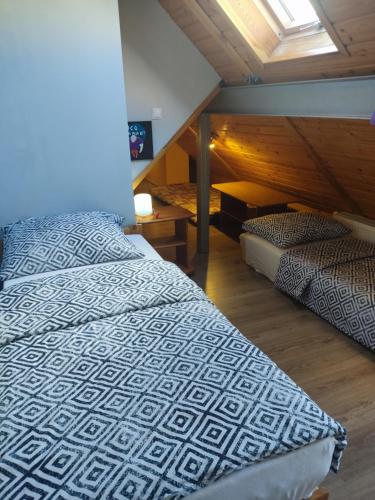 a bedroom with two beds in a attic at Mieszkanie / Apartament centrum blisko szlaków i wyciągów !!! in Szklarska Poręba