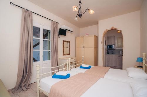 a bedroom with two beds and a window at Giannakas Studios in Platis Yialos Sifnos