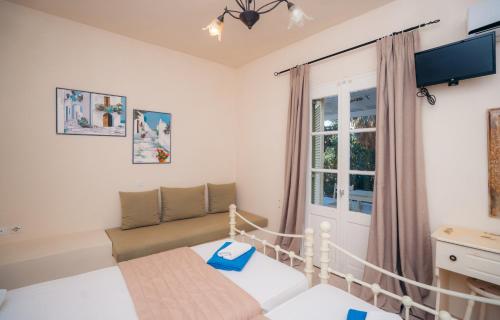 a small bedroom with a bed and a window at Giannakas Studios in Platis Yialos Sifnos