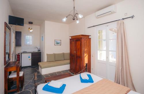 a room with two beds and a couch in it at Giannakas Studios in Platis Yialos Sifnos