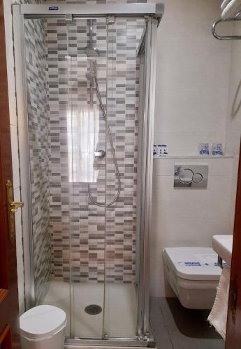 a shower with a glass door in a bathroom at Hostal La Colonia in Marbella