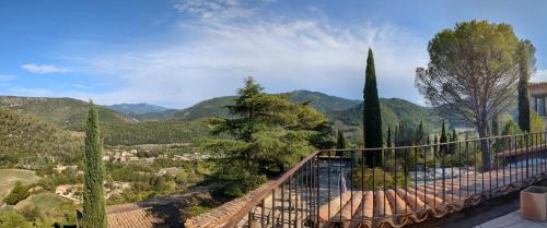 a view from the balcony of a villa with trees and mountains at Les Colombes in Aubres