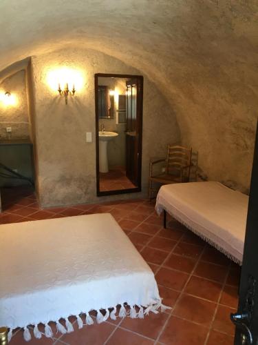 Habitación con 2 camas, lavabo y espejo. en Gite fabuleux Saint Michel en Muro