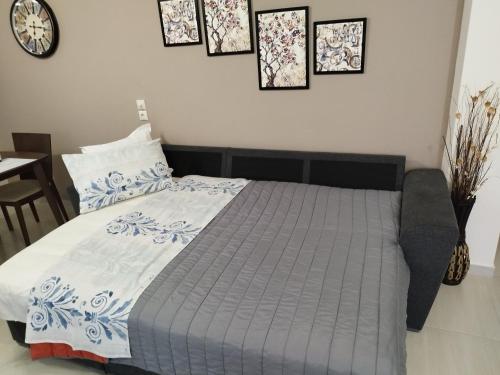 a bedroom with a bed with a blue and white comforter at Meteora countryside villa in Kalabaka