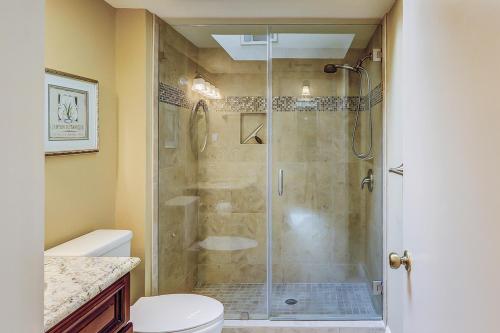 a bathroom with a shower with a glass shower stall at Isle of Pines in Hilton Head Island