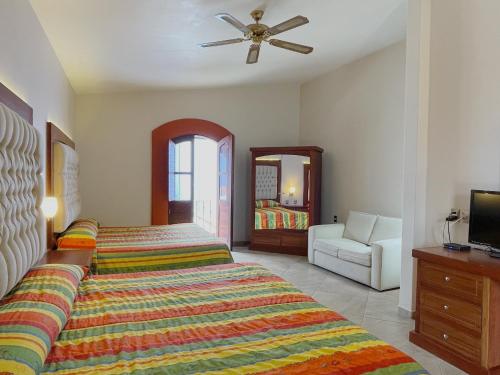 a bedroom with a bed and a ceiling fan at Santa Helena Plaza in Oaxaca City