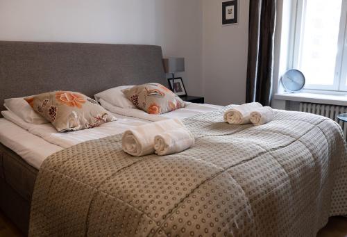 a bedroom with two beds with towels on them at 2ndhomes Luxury Helsinki Center 2BR Apartment with Sauna in Helsinki
