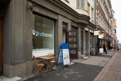a store with a sign on the side of a street at 2ndhomes Luxury 3 BR Brand New 106 m2 Apartment with Spa in Helsinki Center in Helsinki
