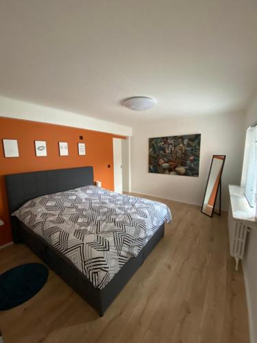 a bedroom with a bed and a wooden floor at Berthe in Blankenberge