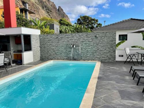 una piscina con patio e una casa di Casa MaBu by Your Madeira Rentals a Paul do Mar