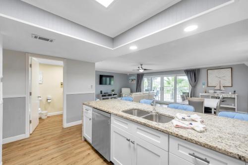 a kitchen with a sink and a living room at Holiday Villas 2 104 in Clearwater Beach