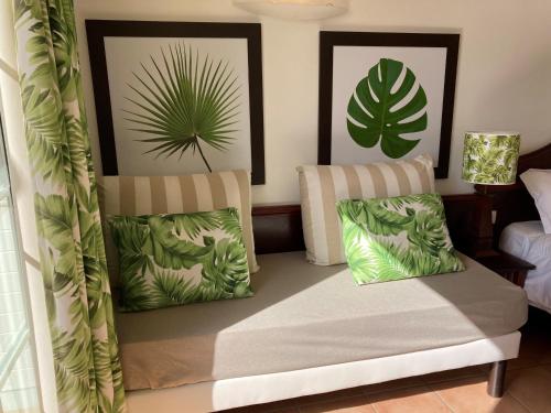 a room with two chairs with plants on the wall at SUPERBE STUDIO MARTINIQUE VUE ROCHER DU DIAMANT in Sainte-Luce