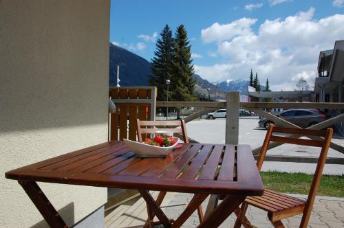 a wooden table with a bowl of fruit on it at Apartments Blažič in Kranjska Gora