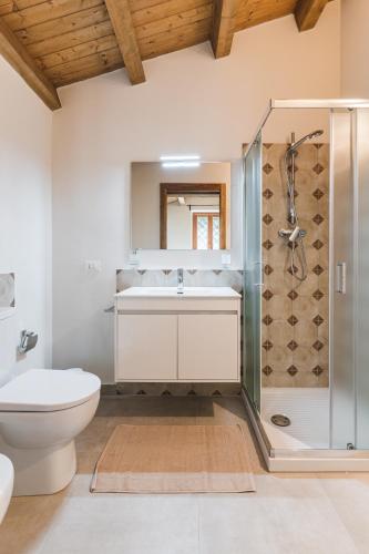 a bathroom with a shower and a toilet and a sink at Alla Riserva - Villa Riserva dello Zingaro - Scopello in Scopello