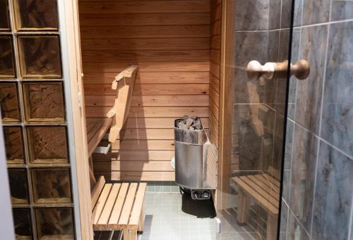 a sauna with a bench and a trash can at 2ndhomes City Center 2BR Apartment with Balcony and Sauna by Kaisaniemi Park in Helsinki