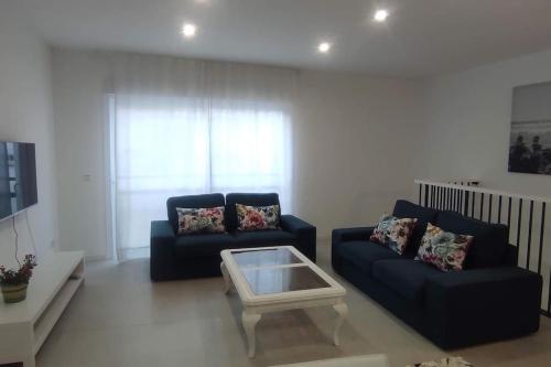 a living room with two couches and a coffee table at Piso en el Centro de La Cala in Mijas Costa
