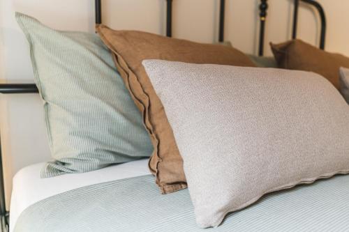 a close up of a bed with pillows on it at Alla Riserva - Villa Riserva dello Zingaro - Scopello in Scopello