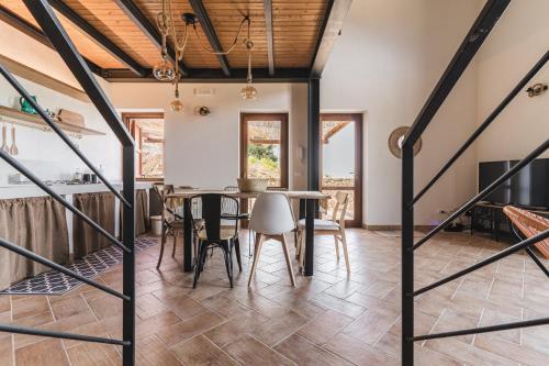 a dining room with a table and chairs at Alla Riserva - Villa Riserva dello Zingaro - Scopello in Scopello