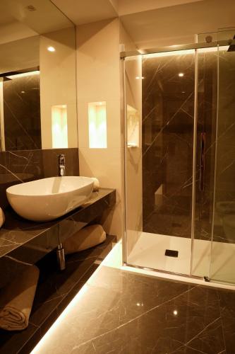 a bathroom with a sink and a glass shower at Hotel Bellavista in Marina di Varcaturo
