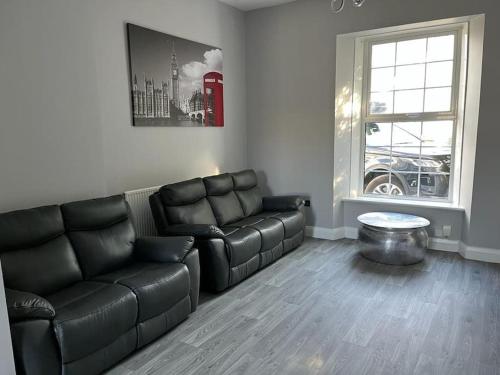 a living room with a couch and a coffee table at 3 Bedroom Self Contained Ground Floor Flat With Parking in Plymouth