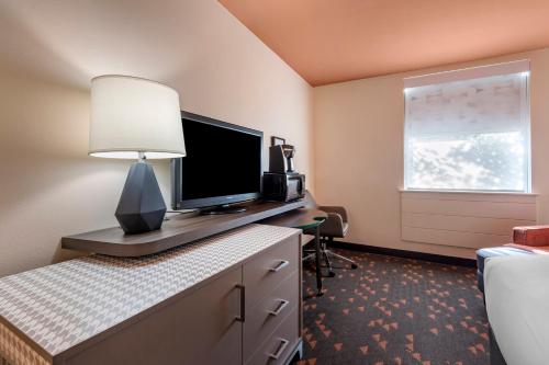 a room with a desk with a monitor and a lamp at Holiday Inn Bangor by IHG in Bangor