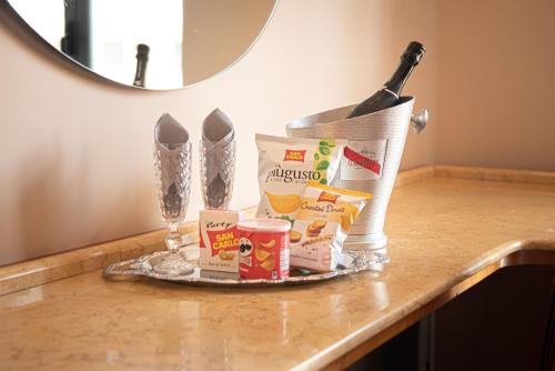a counter with a tray of food and a bottle of wine at Hotel Bellavista in Marina di Varcaturo