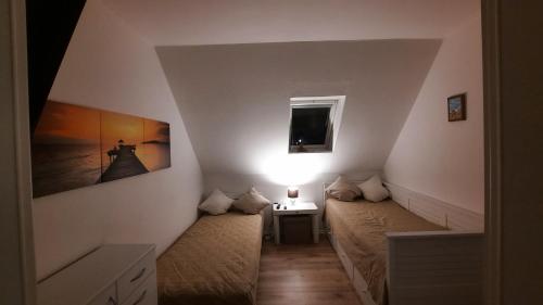 WesterdeichstrichにあるFerienwohnung Goden-Windのベッドと窓が備わる小さな客室です。