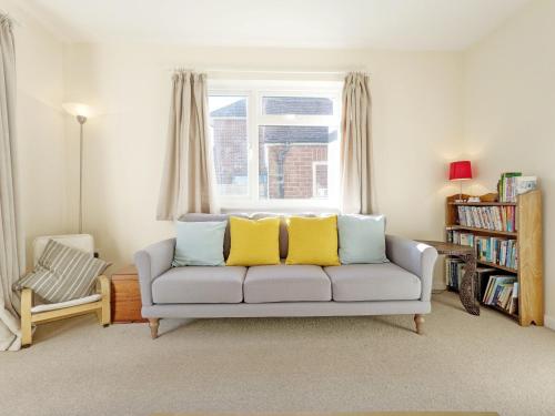 a living room with a couch and a window at Beacon Square, Emsworth in Emsworth