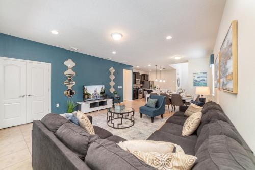 a living room with a couch and a dining room at Blue Stylish Charming Villa with Pool near Disney in Kissimmee
