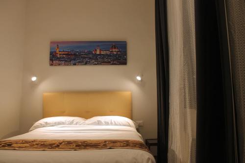 Postel nebo postele na pokoji v ubytování Hotel 900 Toscana