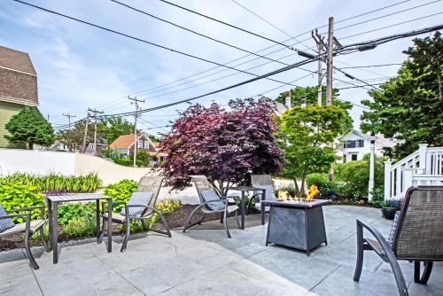 a patio with chairs and tables and a tree at Admiral's Landing in Provincetown