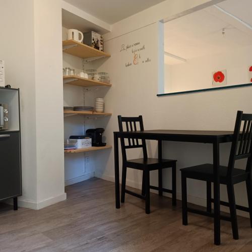 a dining room with a table and two chairs at Studio Bourbon in Bourbon-lʼArchambault