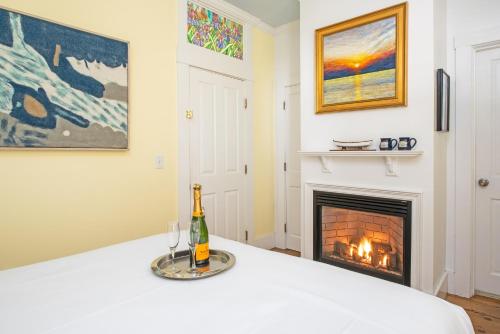 a living room with a fireplace and a bottle of champagne at Admiral's Landing in Provincetown