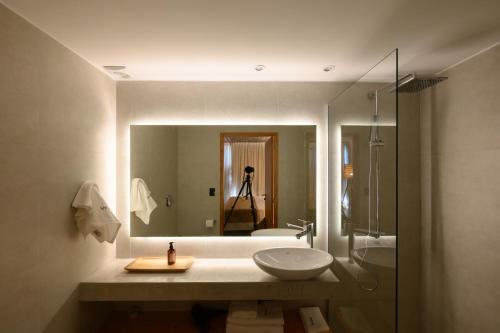 a bathroom with a sink and a shower and a mirror at Ambar Hotel in Punta del Este