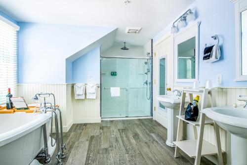 a bathroom with two sinks and a shower at Admiral's Landing in Provincetown