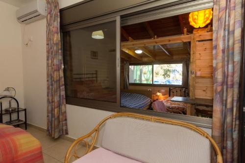 a bedroom with a large window and a bed in a room at Country lodging in Manot in Manot