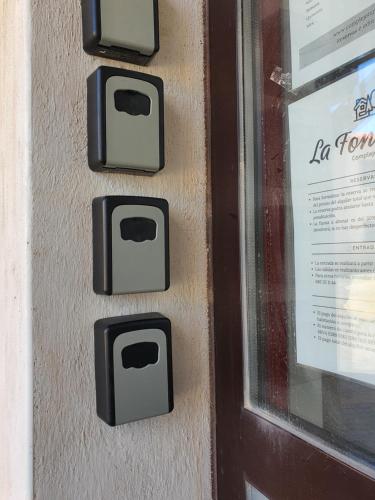 a bunch of switches on a wall next to a door at Albergue la Fontanina ALCC00043 in Mata de Alcántara