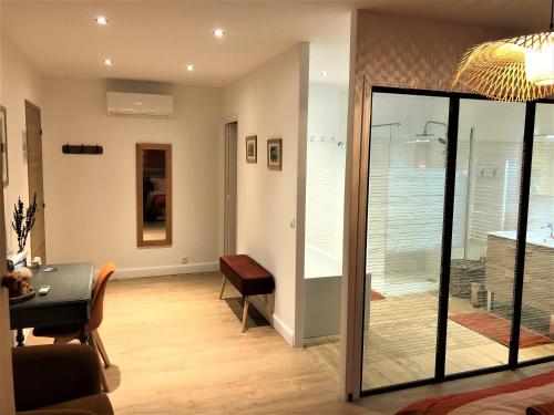 a living room with a table and a glass door at Le Mas Justin in Gordes