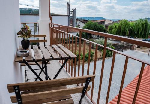 a wooden bench sitting on top of a balcony at Casa Ferradal 