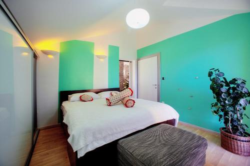 a bedroom with green and white walls and a bed at Villa Barbara in Skradin