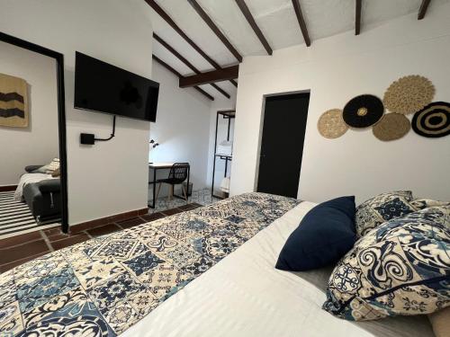 a bedroom with a bed and a flat screen tv at Casa Medallo in Medellín