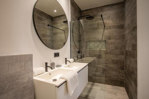 a bathroom with a sink and a mirror at Blue Bay Reef apartment 19 in Sint Michiel