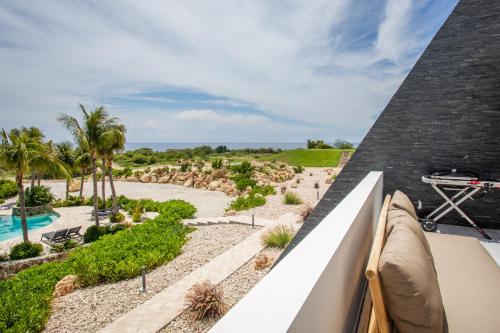 a view of the pool from the balcony of a resort at Blue Bay Reef apartment 19 in Sint Michiel
