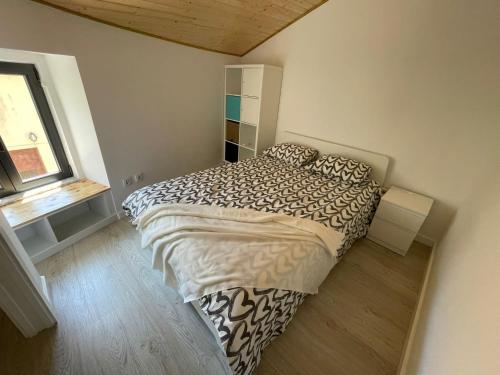 a bedroom with a bed and a window at Casinha da fonte in Arcos de Valdevez