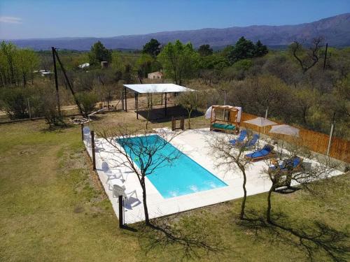 an overhead view of a swimming pool in a field at Cabañas Tierra del Sol in Las Rabonas