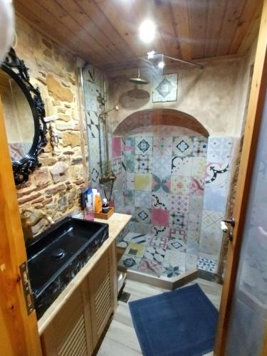 a bathroom with a sink and a stone wall at Mastixi in Chios
