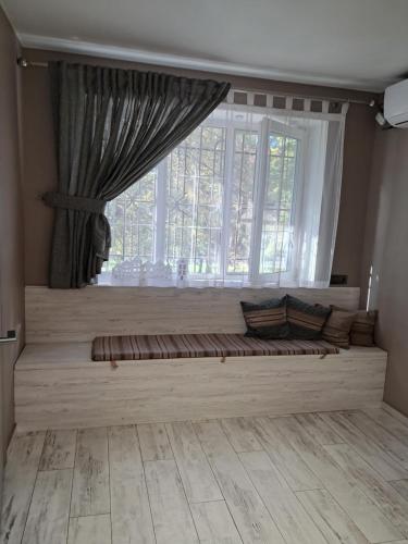 a window seat in a room with a large window at super apartment on O.Polya 137 in Dnipro