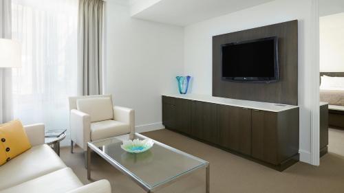a living room with a couch and a tv at InterContinental Cleveland by IHG in Cleveland