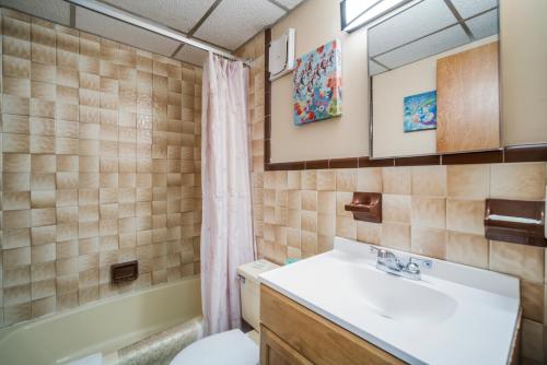 a bathroom with a sink and a toilet and a tub at Sahara Motel in North Wildwood